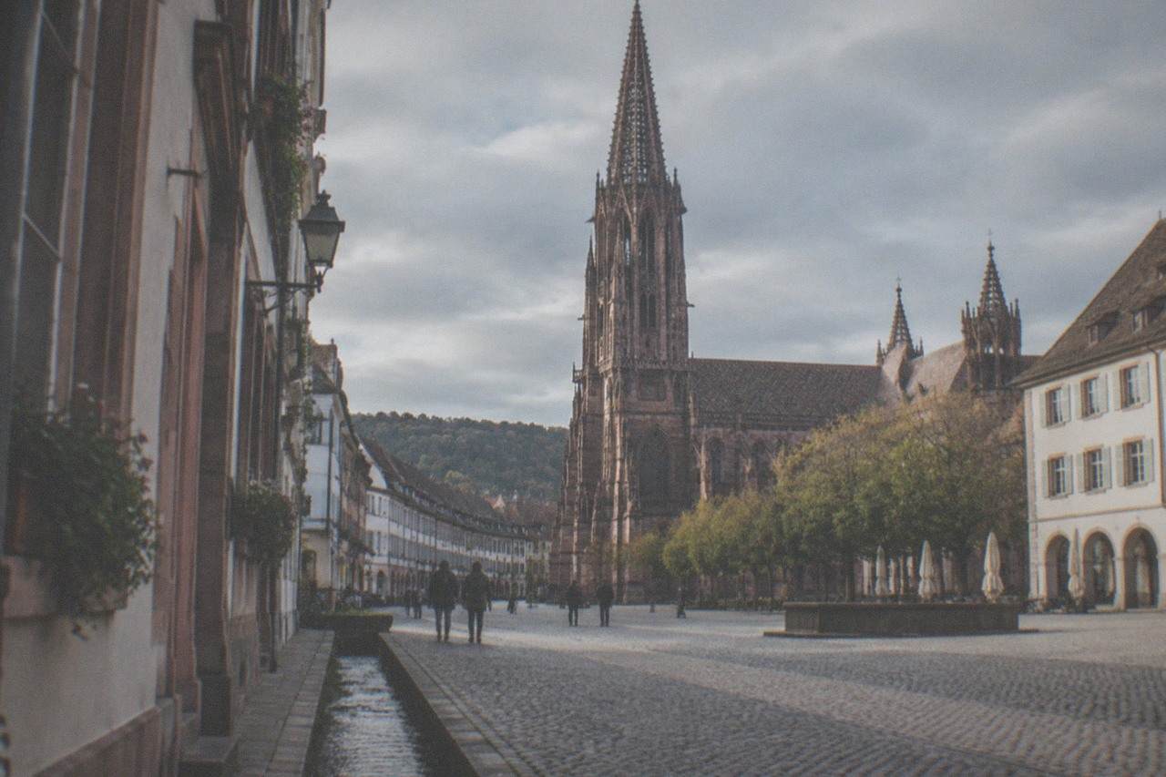 Cobbled street in Freiburg old town with a small water channel running alongside the pavement