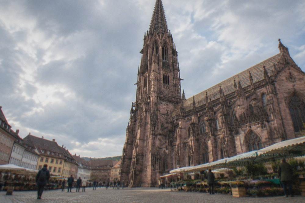 Cobbled old town square with a Gothic sandstone cathedral and market stalls