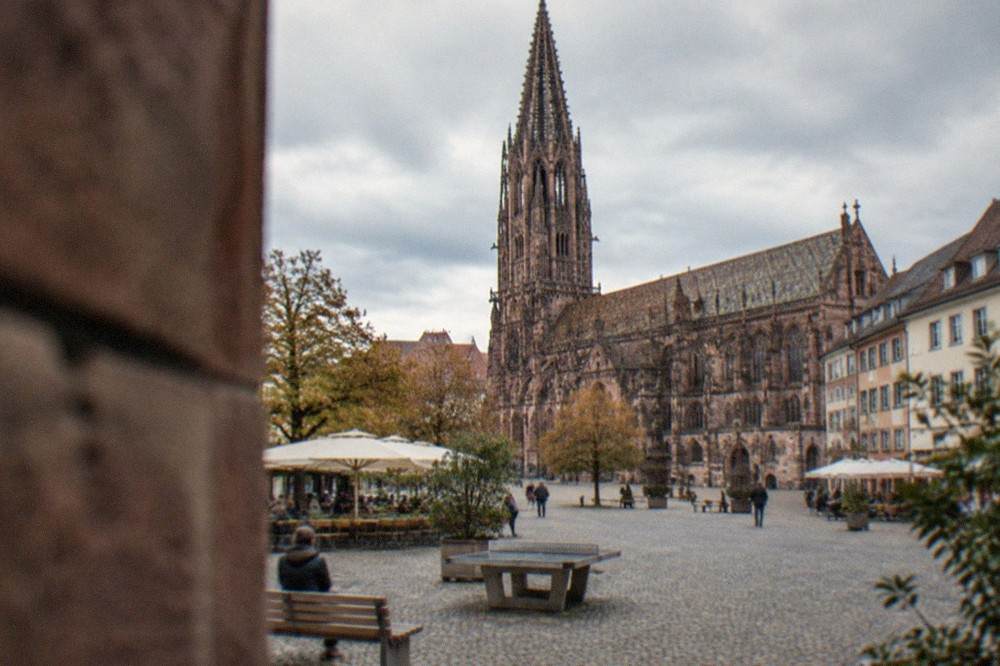 Neighborhood square with benches, a table tennis table and café facades in Freiburg