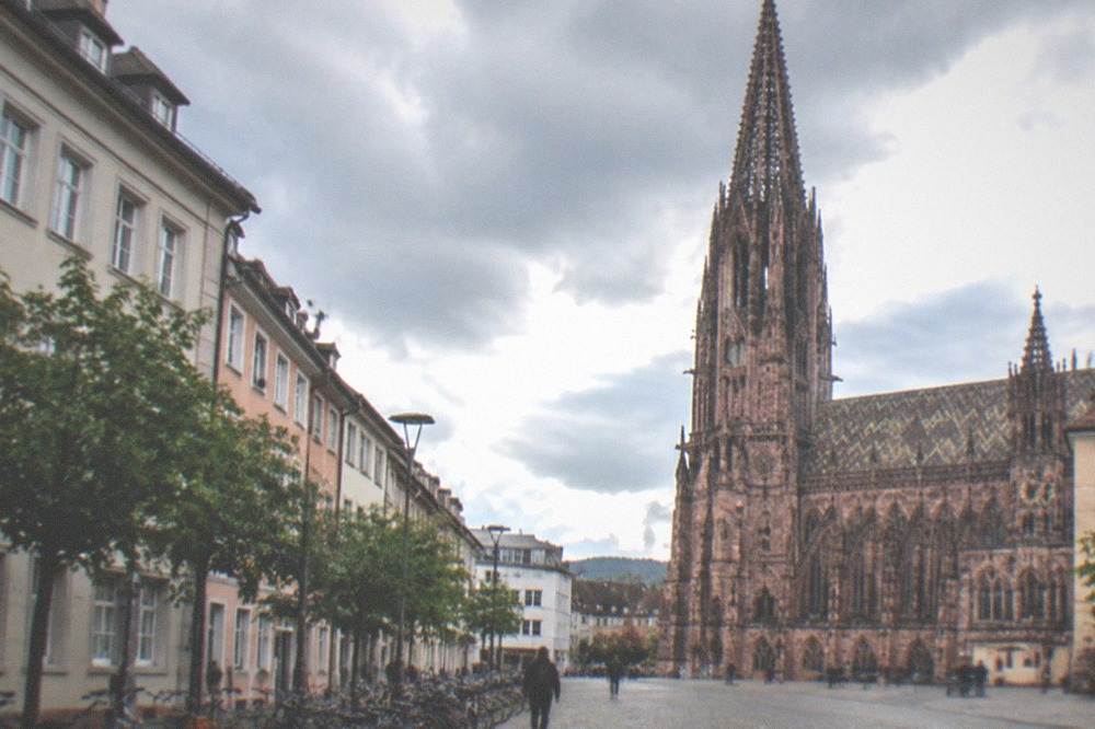 Hotel facades and parked bicycles along a wide street near Freiburg main station