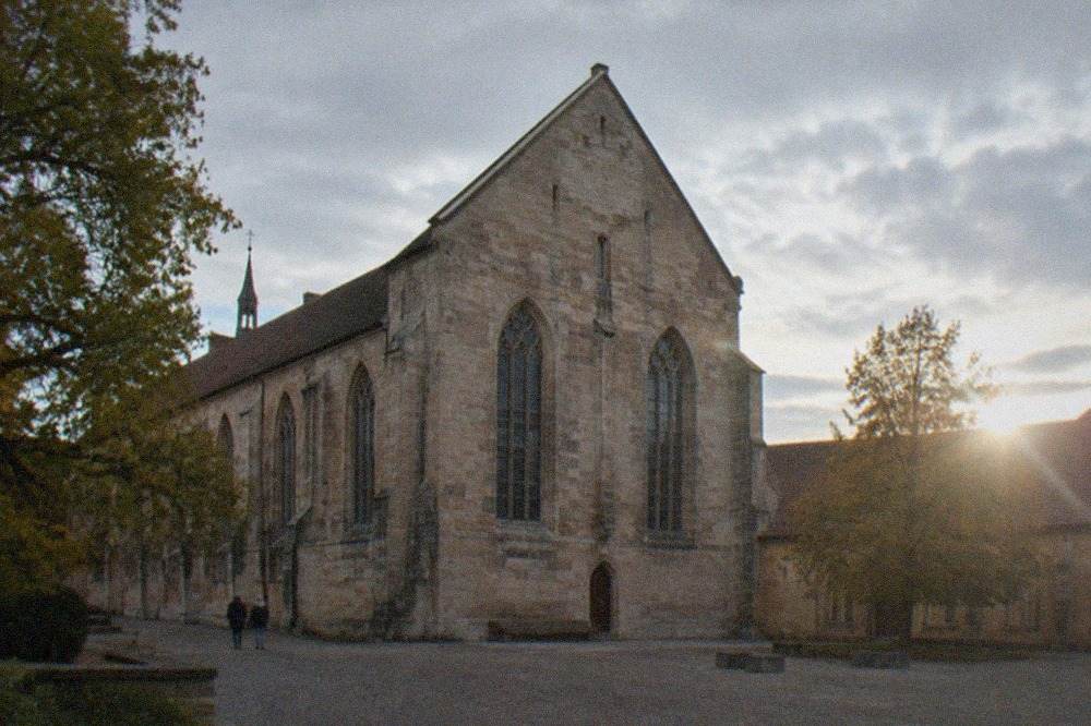Gothic church interior of the Augustinermuseum with stone columns and stained glass windows