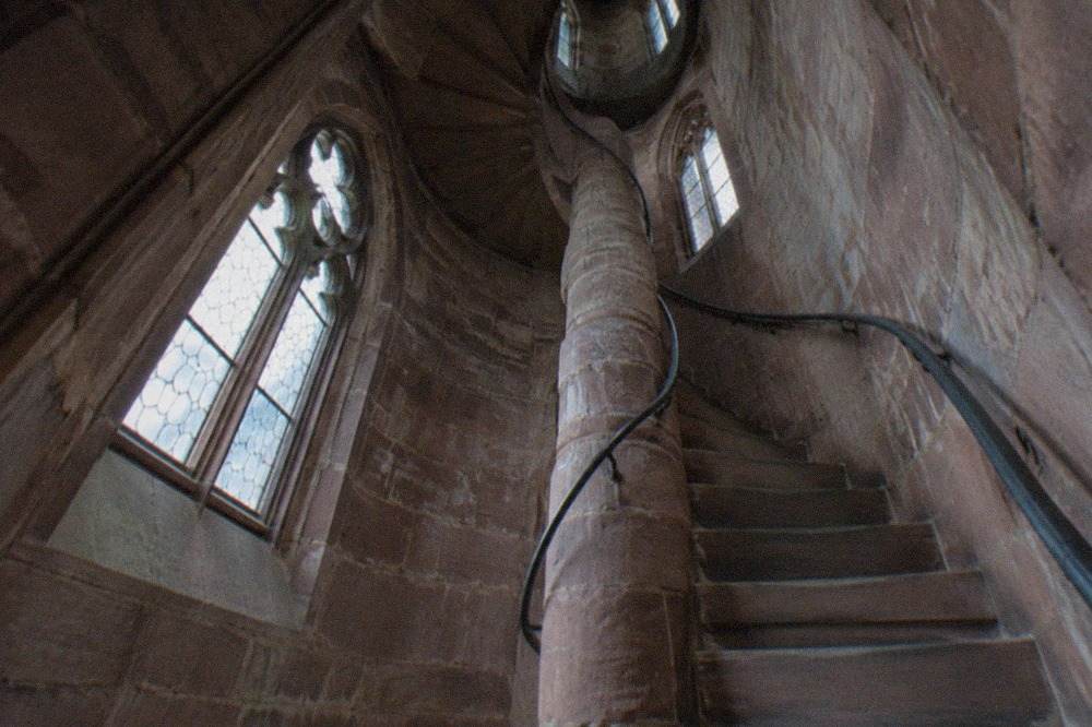 Spiral stone staircase inside the minster tower seen from below