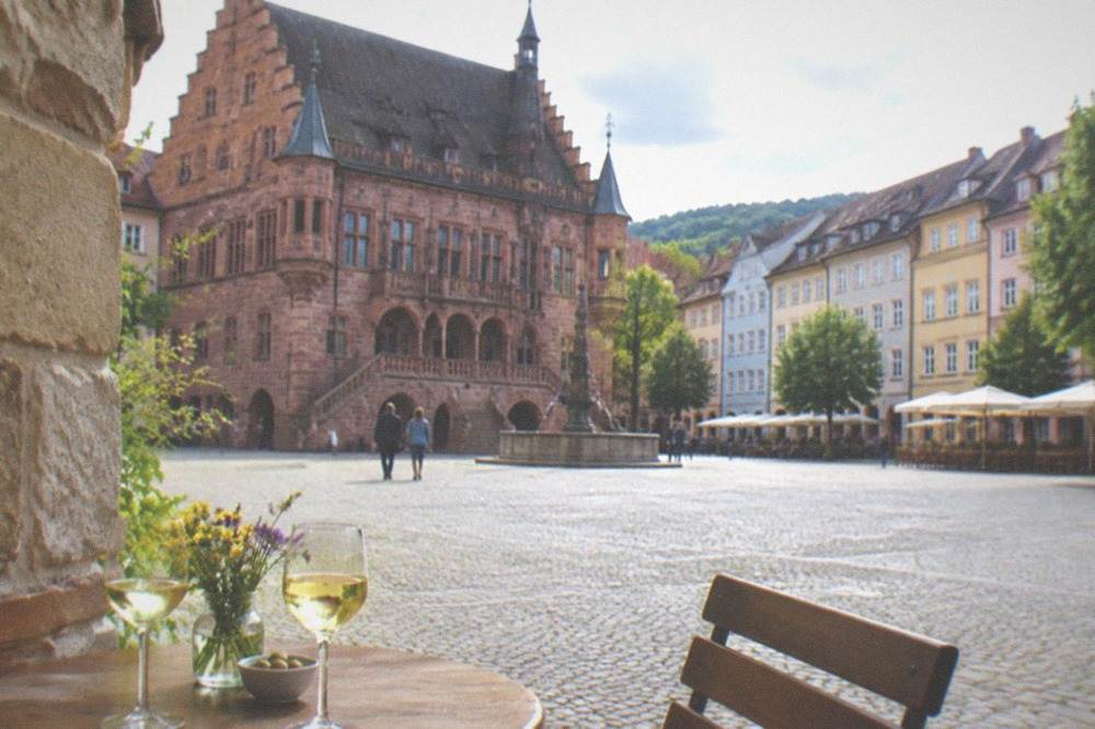 Small wine tavern table setting beside a stone facade in an old lane