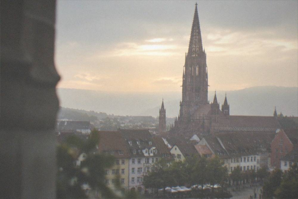 Evening light over Freiburg rooftops with the Münster tower in the distance