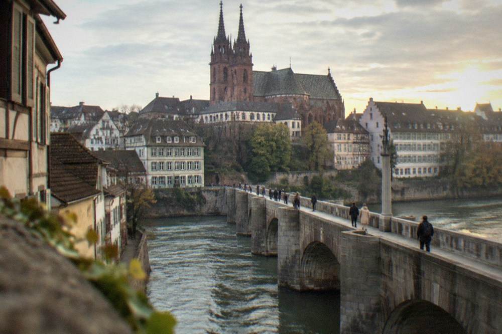 The middle bridge over the Rhine with walkers crossing toward Basel's old town