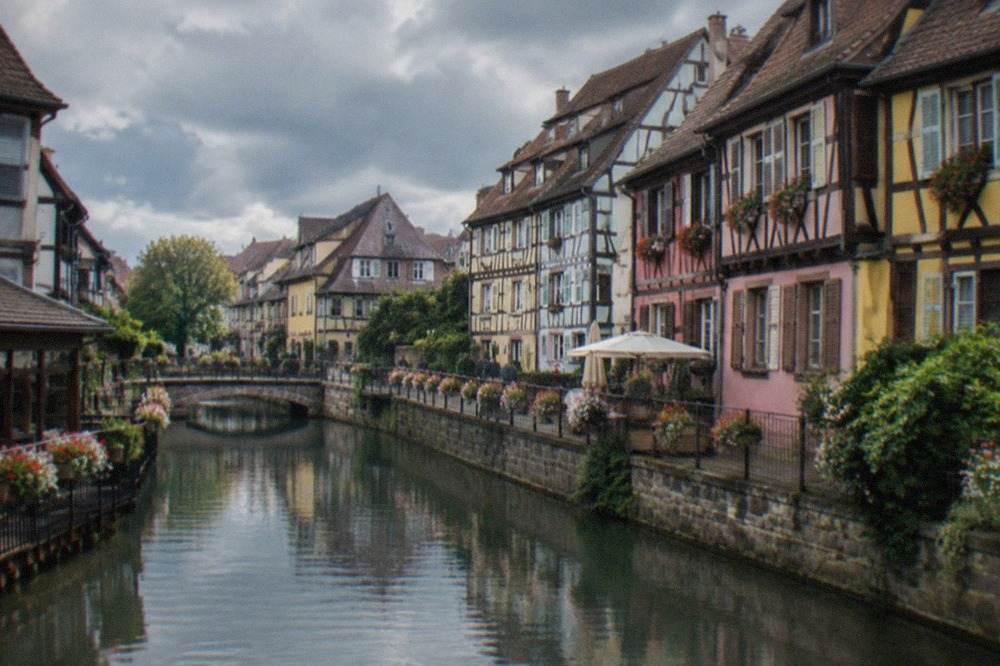 Pastel half-timbered houses along a canal in Colmar old town