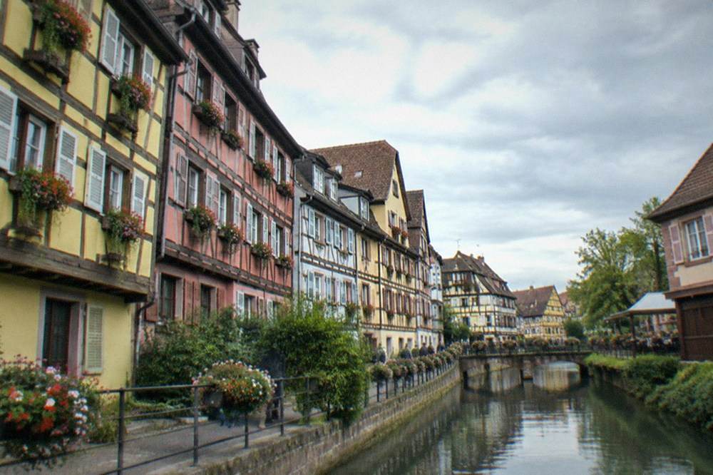 Narrow street of colorful half-timbered buildings in central Colmar