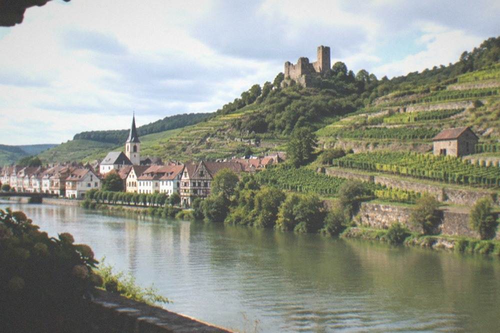 Small historic town with half-timbered houses and a hillside castle ruin