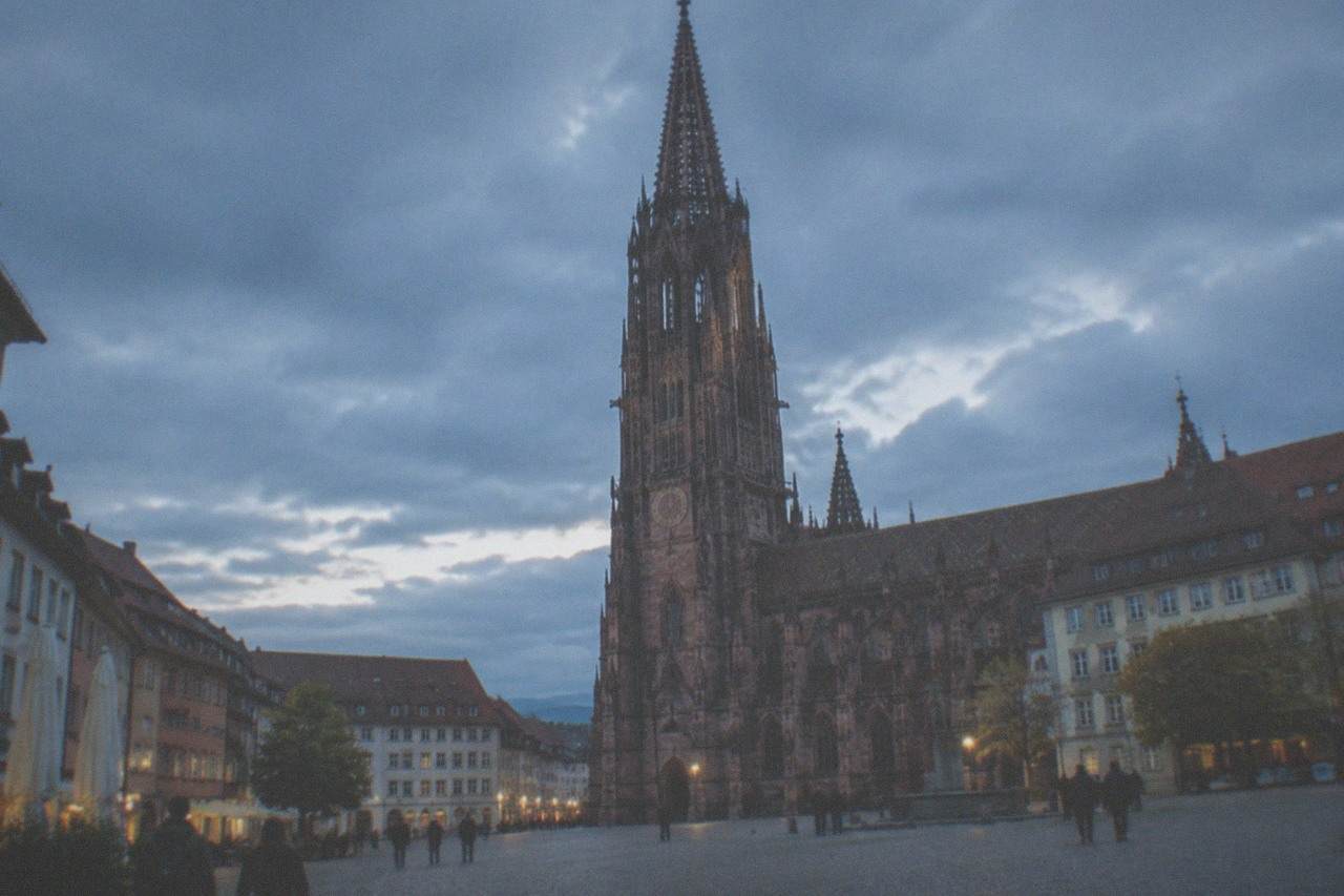 Freiburg Minster rising above red roofs of the old town on a clear day
