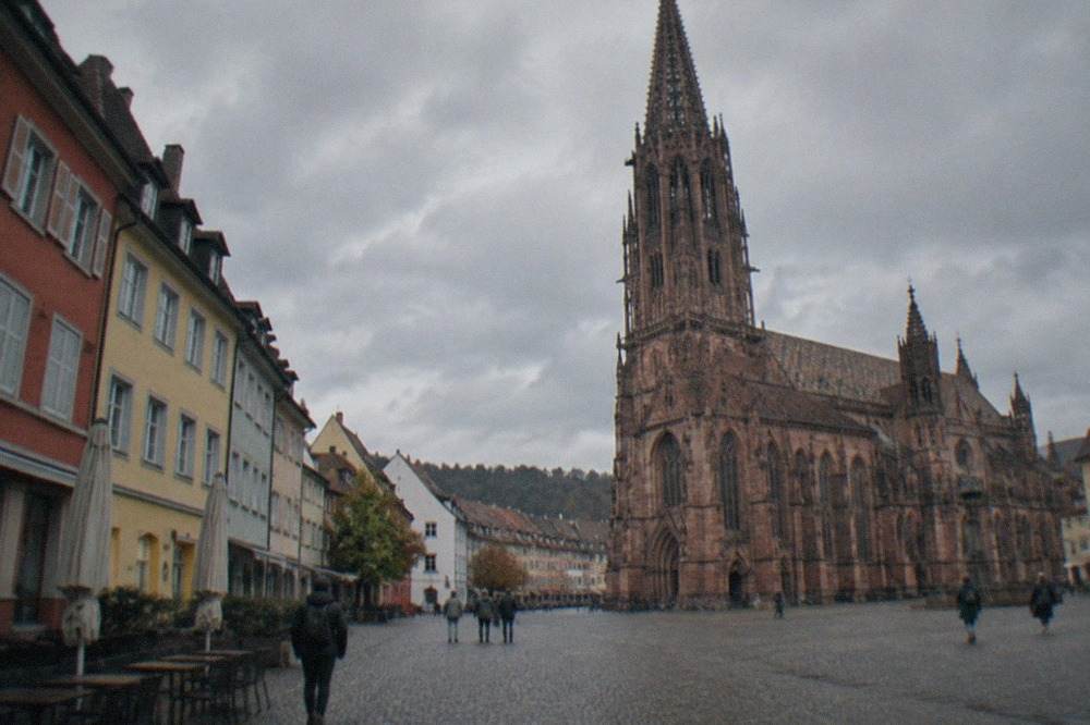 Cobblestone street in Freiburg old town lined with colorful facades
