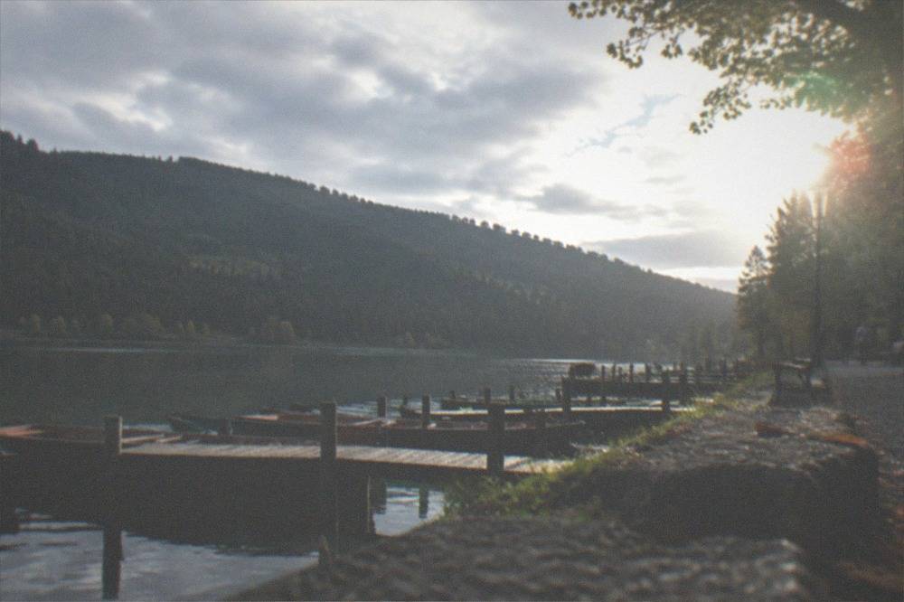 A lakeside promenade at Titisee with forested hills rising behind calm water