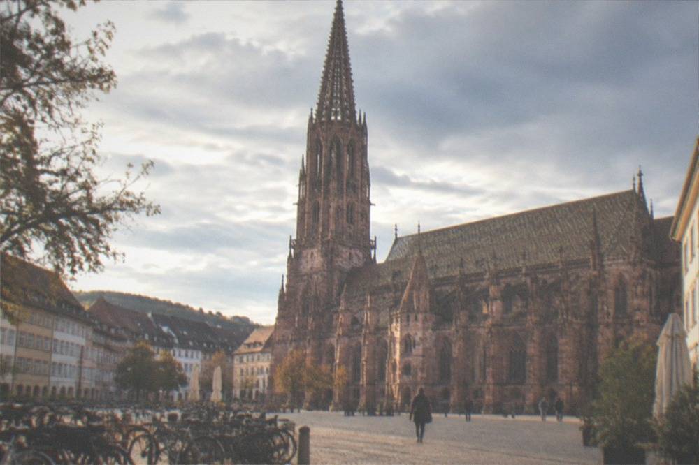 Bicycles parked in a sunlit Freiburg square with warm afternoon light