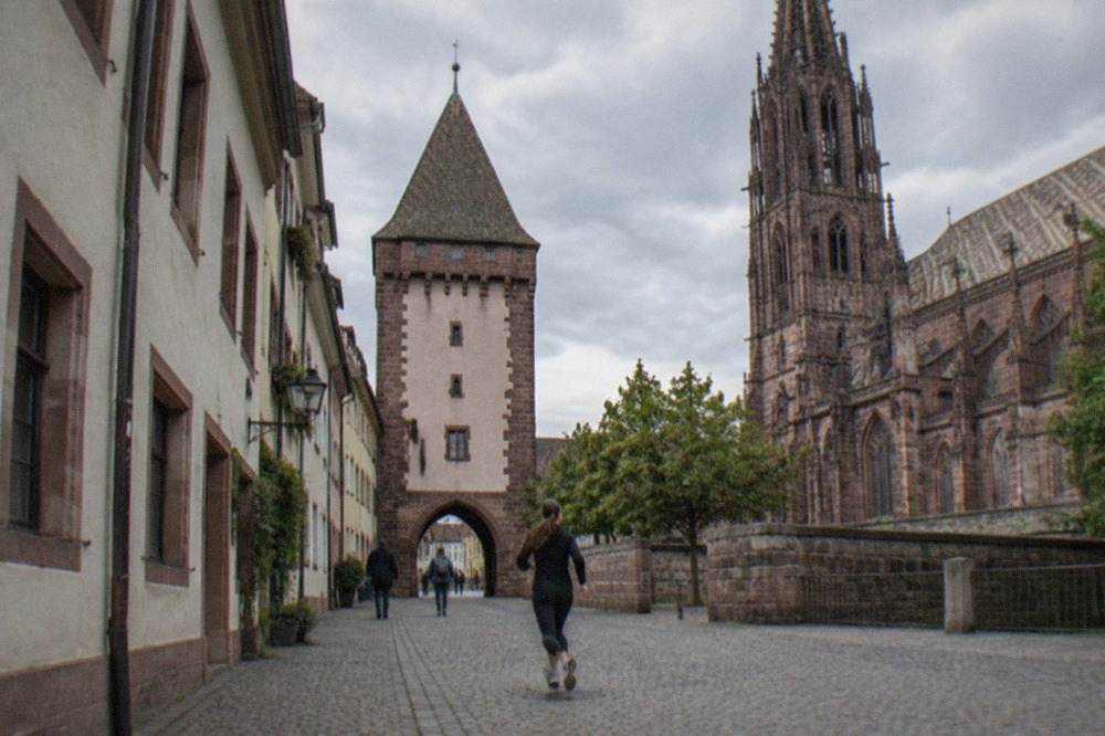 Medieval city gate tower on a narrow street in Freiburg old town