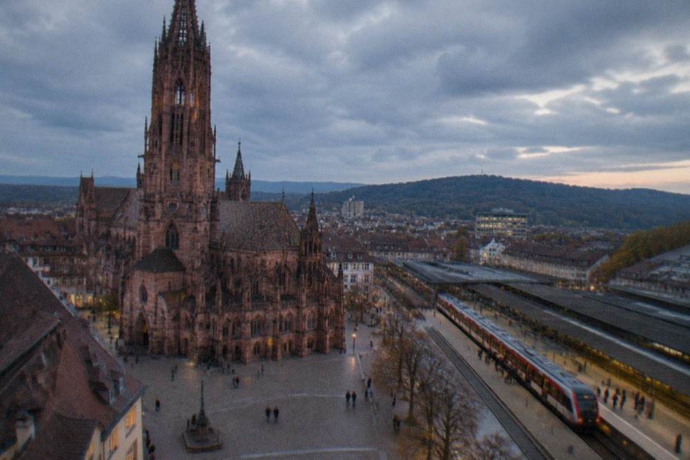 Freiburg main station platform with regional train and passengers boarding
