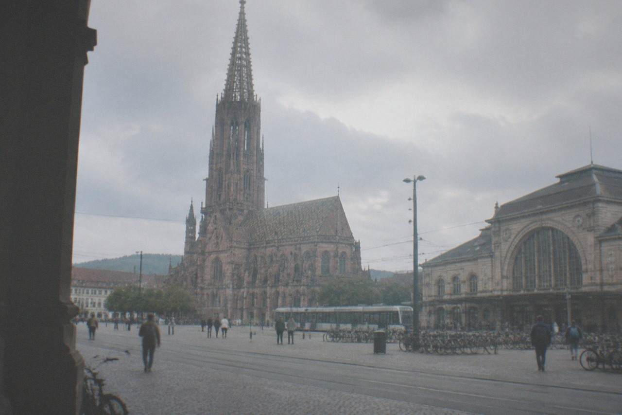 Freiburg Hauptbahnhof station building with tram tracks and bicycles outside the entrance