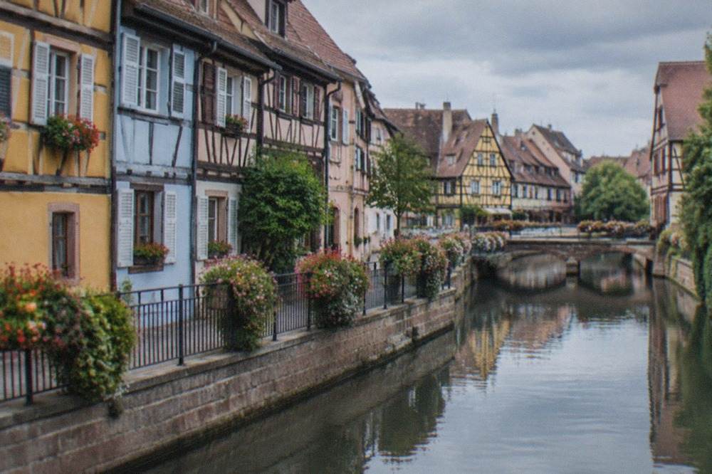 Half-timbered Alsatian houses reflected in a canal in Colmar old town