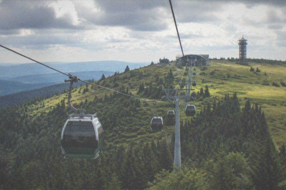 The Schauinslandbahn gondola cabins traveling up a green mountainside toward the summit station