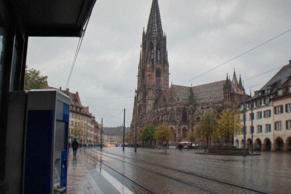 A ticket machine on a Freiburg tram platform with tracks curving away behind it