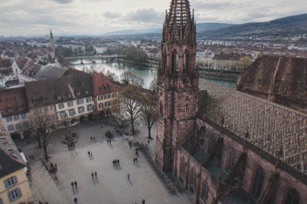 People strolling on a wide plaza in central Freiburg on a bright afternoon with bicycles parked along the edge