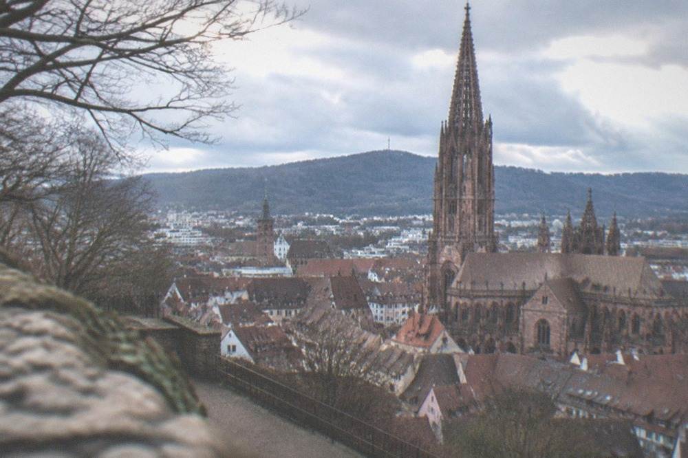View from Schlossberg over Freiburg's Old Town with the Münster tower rising above the rooftops.