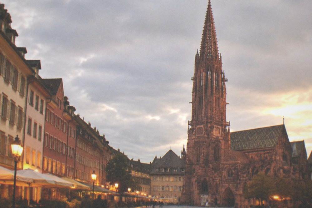 Evening street scene with lantern light on old town buildings in Freiburg
