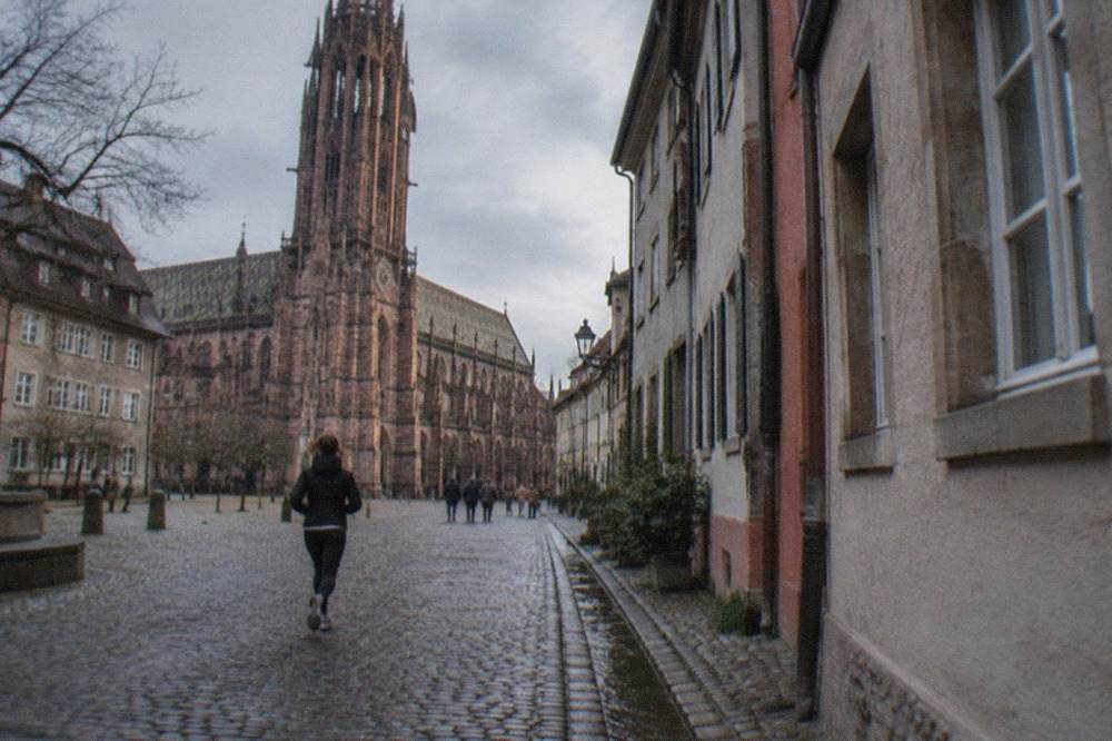 Cobblestone lane in Freiburg old town with a small water gutter running alongside