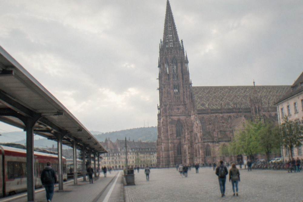 Regional train at Freiburg Hauptbahnhof with platforms and station canopy