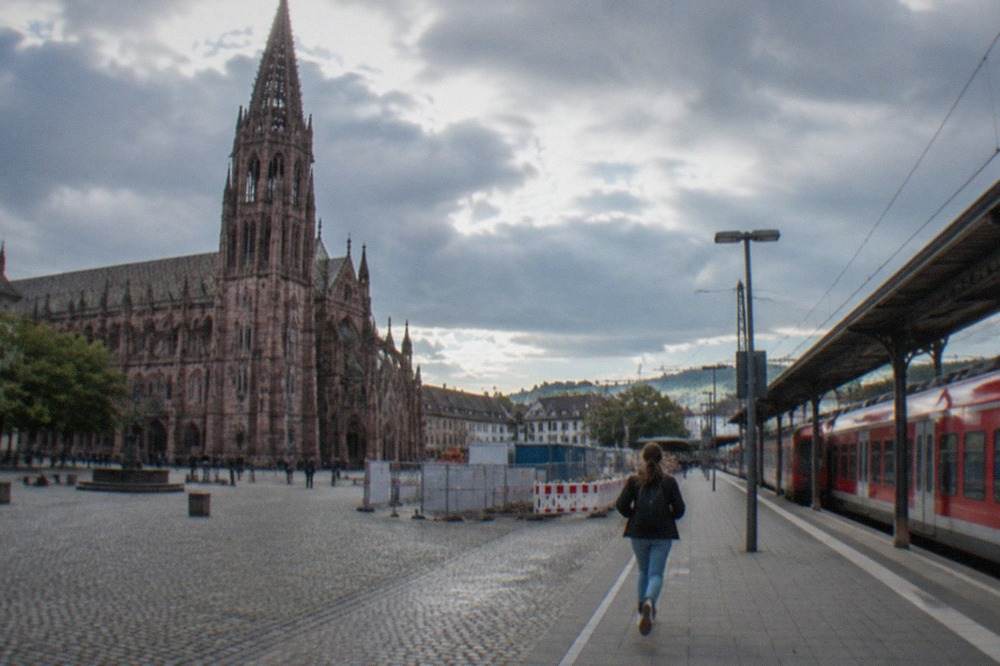 Freiburg Hauptbahnhof platform with a red regional train and construction hoardings