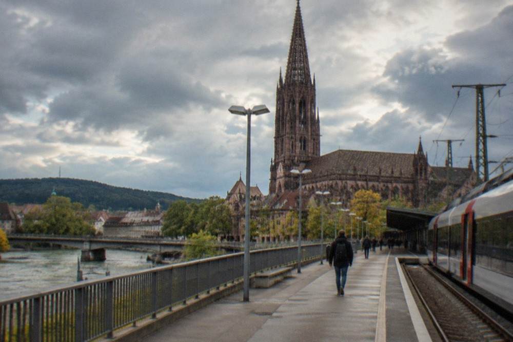 Regional train platform at Freiburg Hauptbahnhof with a departure board
