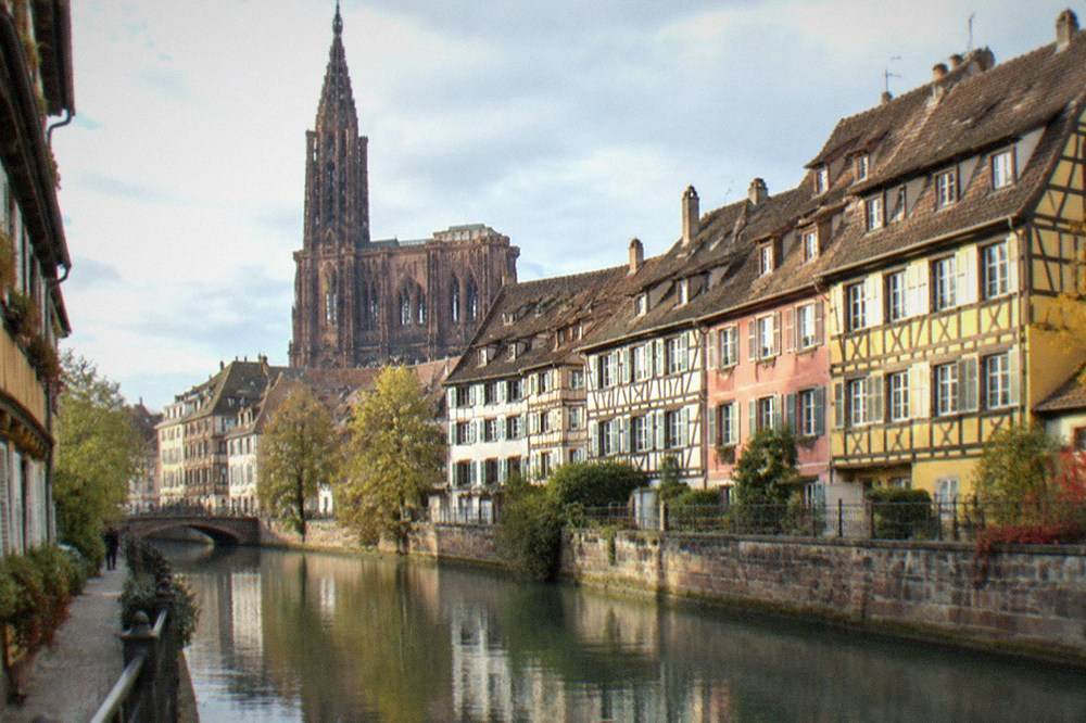 Strasbourg cathedral facade towering over the old city roofs