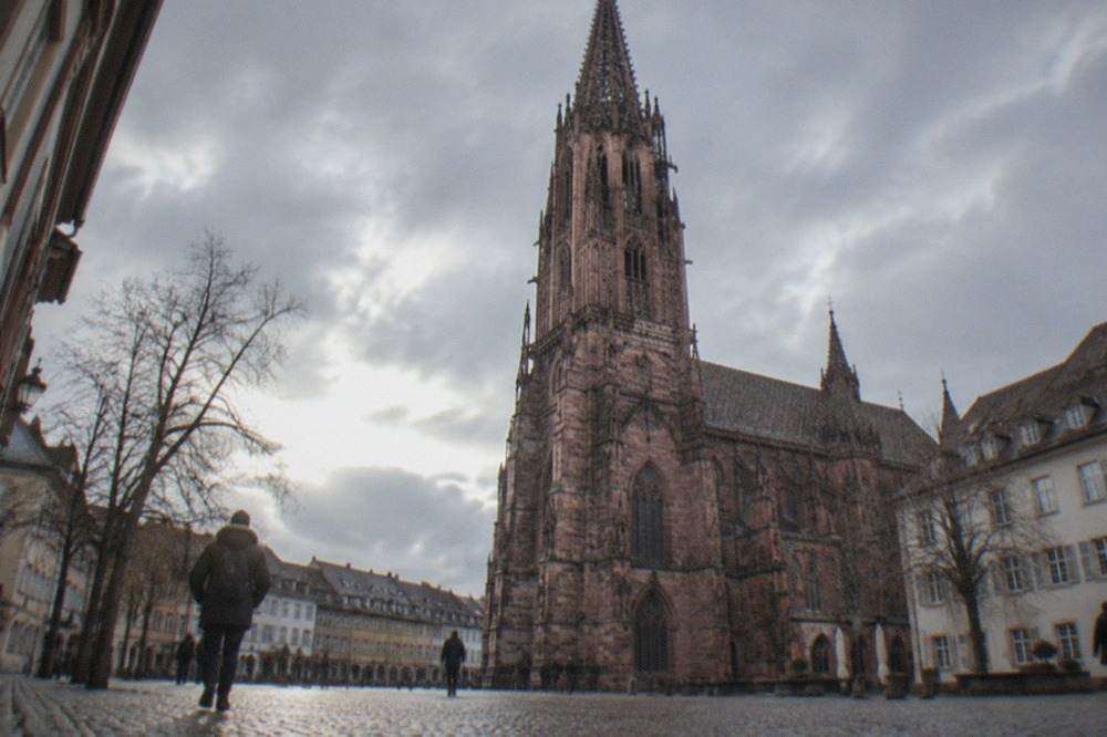 Frieburg Old Town street with the Gothic Münster tower rising above winter rooftops