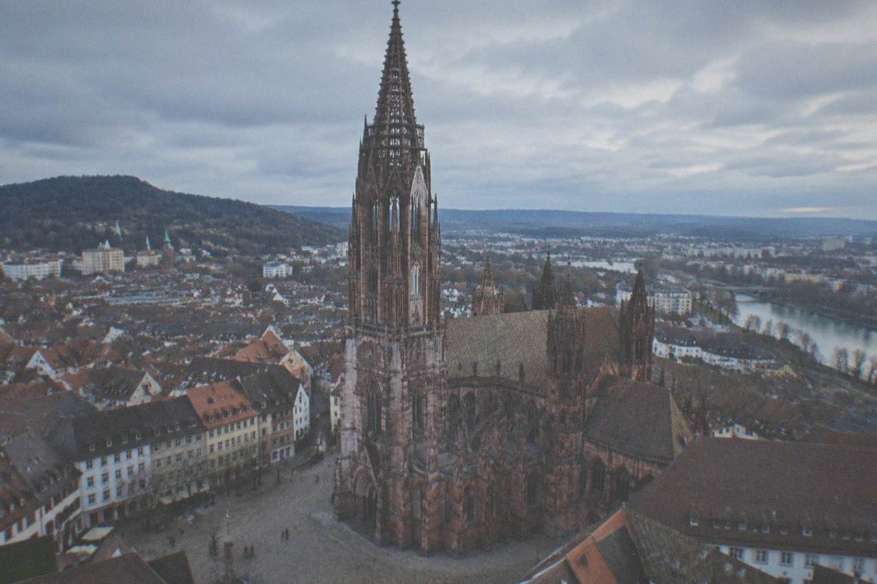 Freiburg Minster rising above the roofs of the old town in morning light