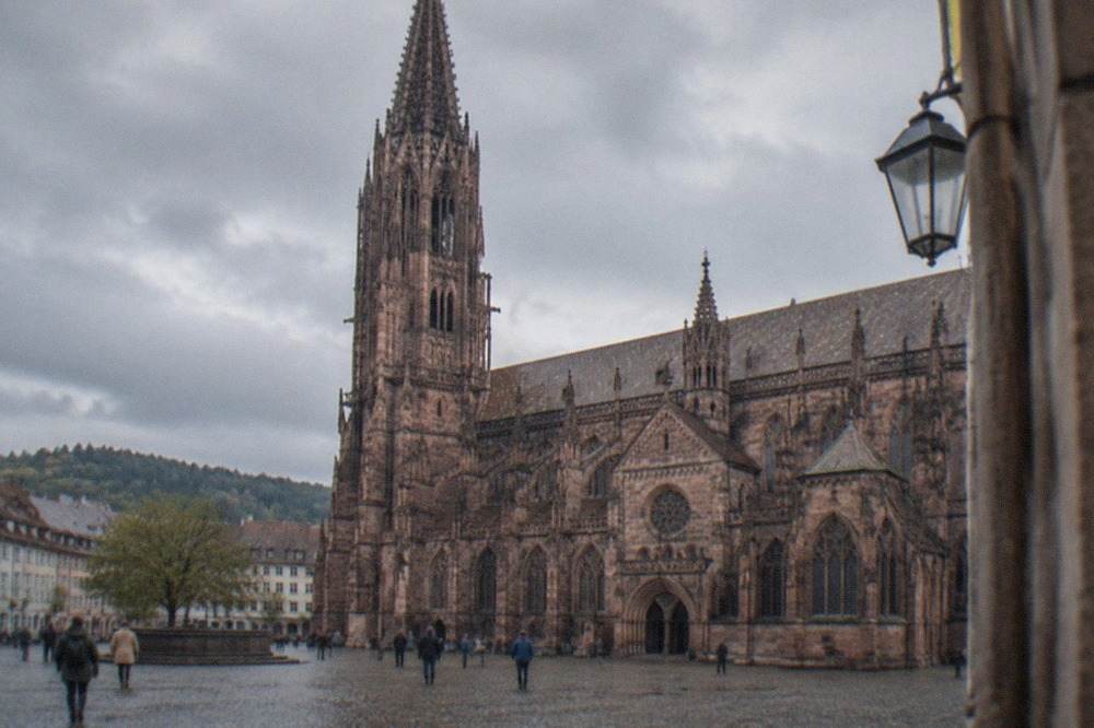 The west tower and Gothic facade of Freiburg Minster seen from Münsterplatz